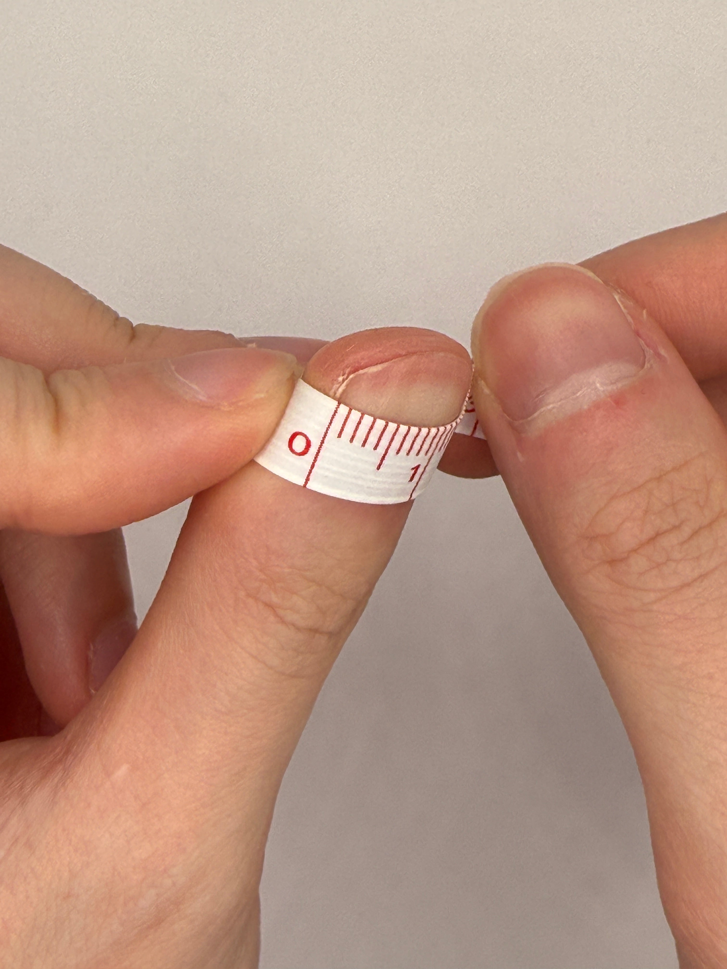 Measuring a nail with tape, step 1